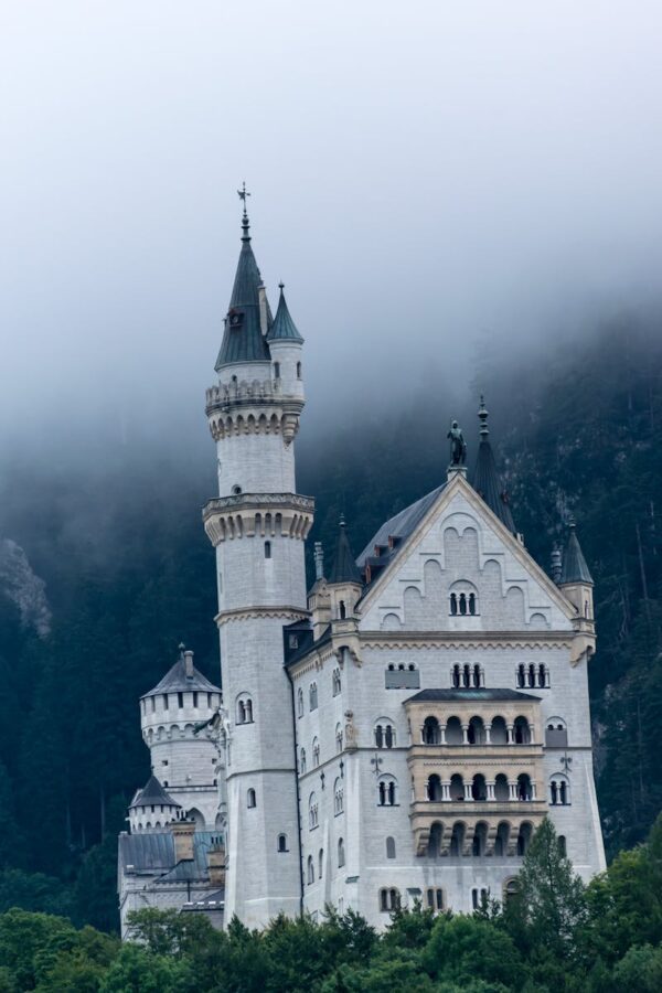 Stunning view of Neuschwanstein Castle emerging from the mist in Bavaria.